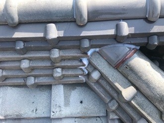 隅棟と大棟の接合部分にコーキング（シーリング）で補強する作業風景